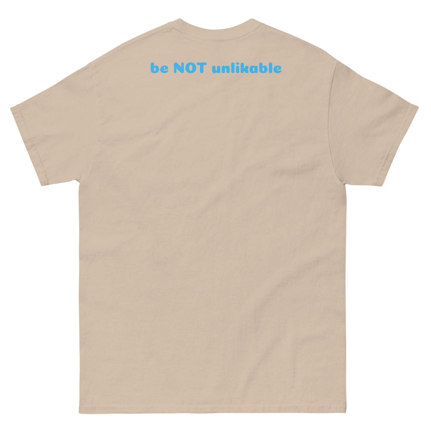 sand t-shirt with 'be NOT unlikable' text on the back against a white background