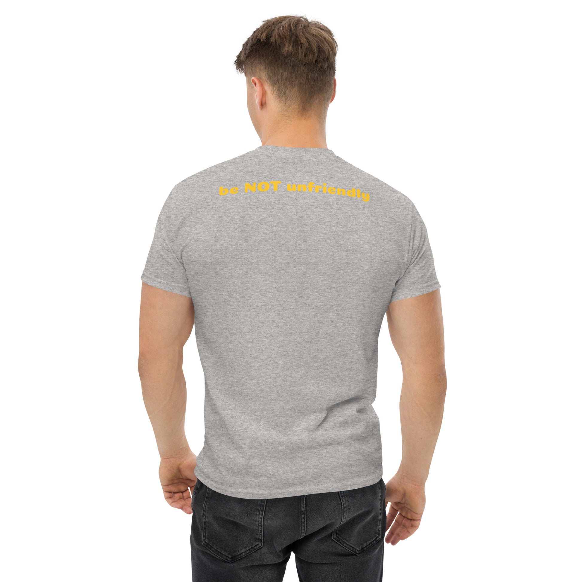 Man wearing a gray t-shirt with yellow text on the back, standing against a white background