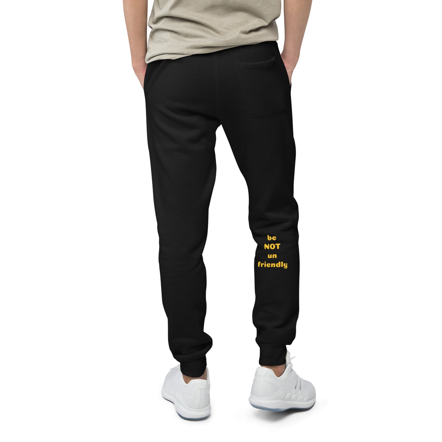 Person wearing black sweatpants with yellow text on a white background