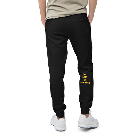 Person wearing black sweatpants with yellow text on a white background