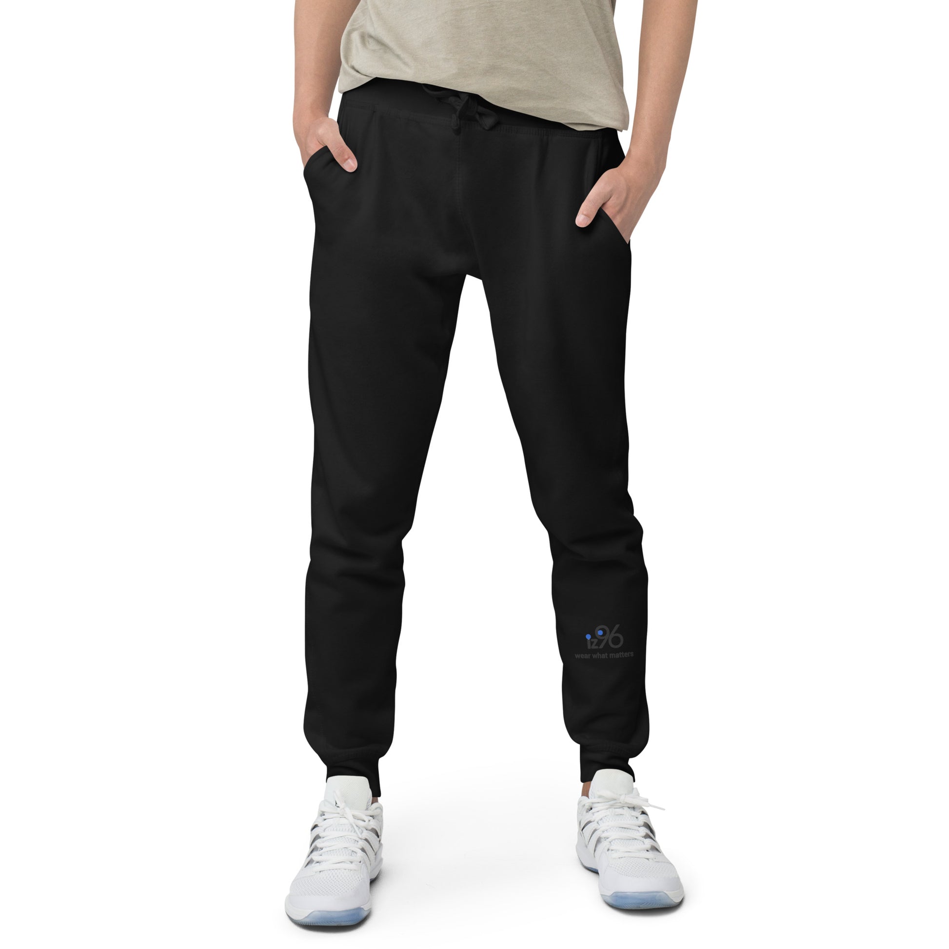 Person wearing black jogger pants with a brand logo on a white background