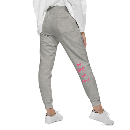 Person wearing gray sweatpants and white sneakers on a white background