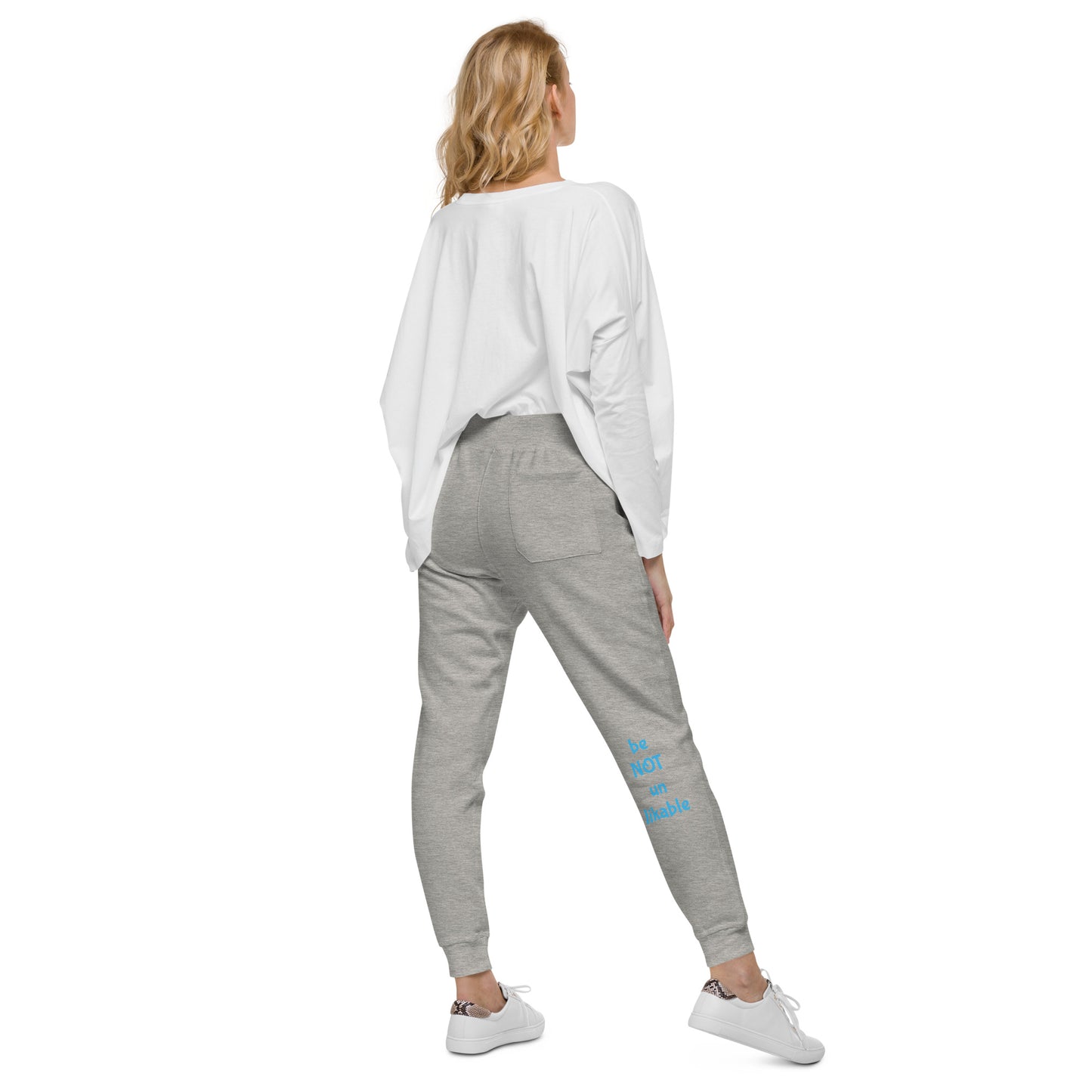 Woman wearing gray sweatpants with blue text on a white background