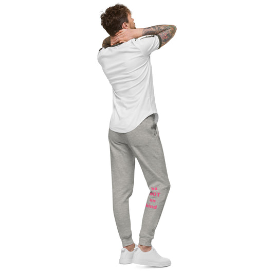 Man wearing a white t-shirt and gray jogger pants with pink text on a white background
