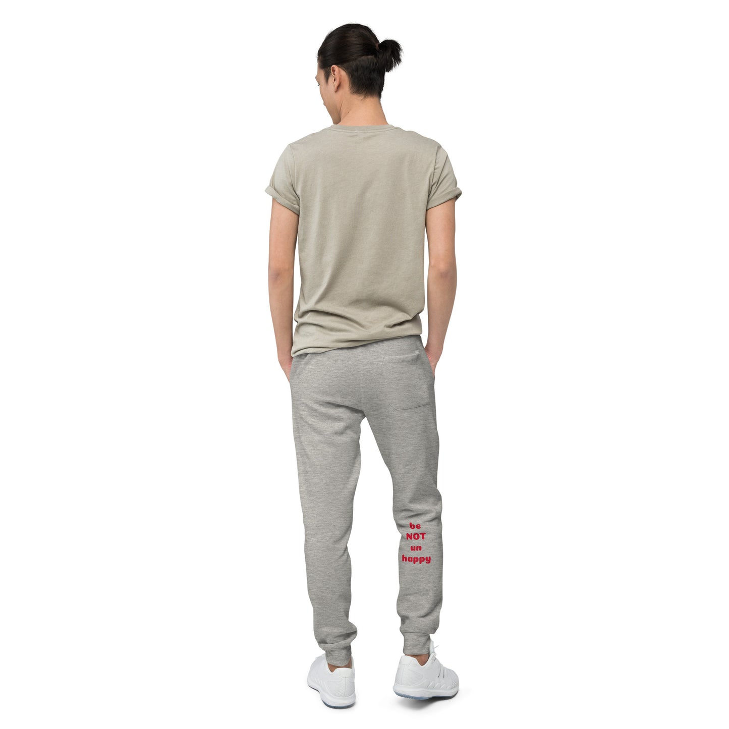 Person wearing a gray t-shirt and gray sweatpants with text on a white background