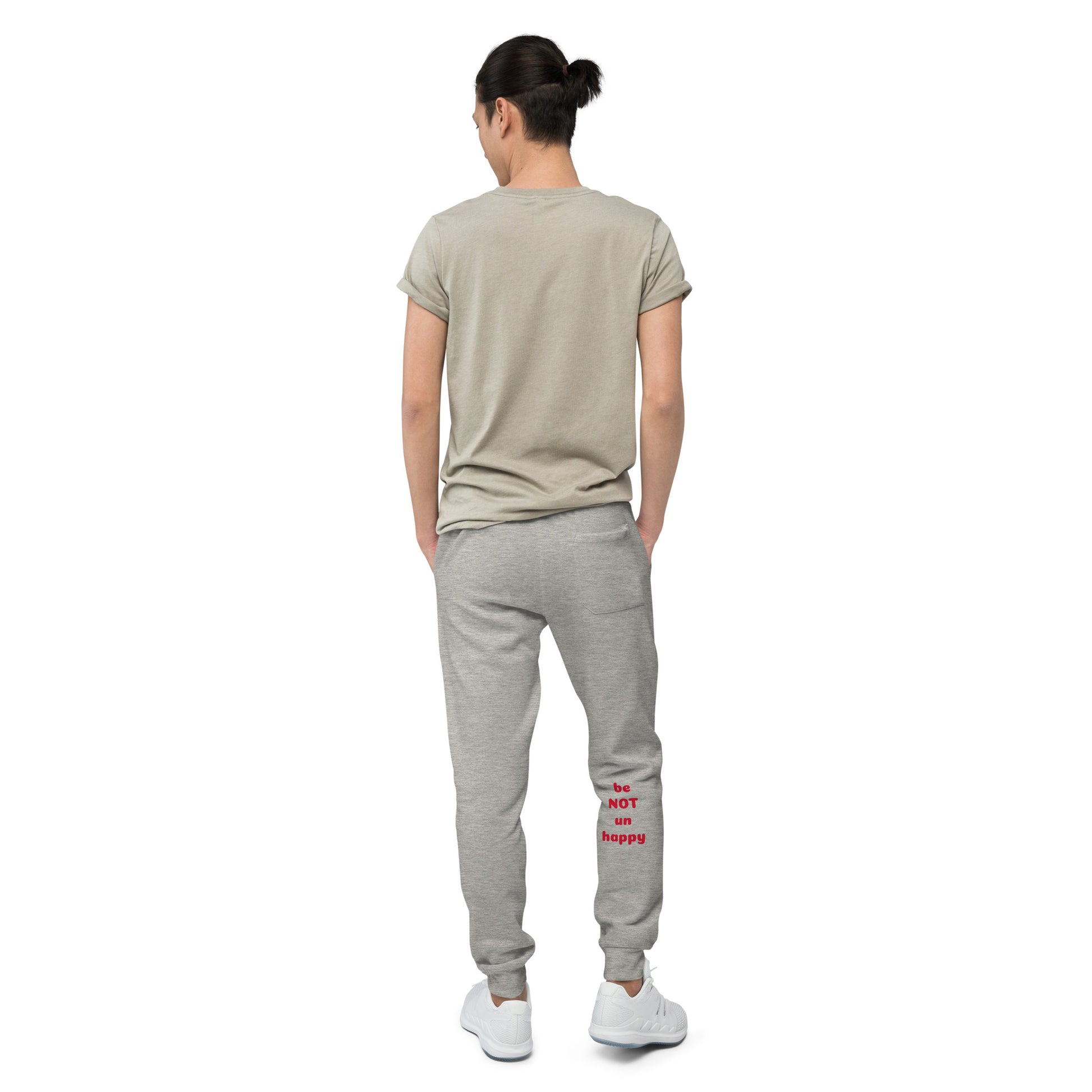 Person wearing a gray t-shirt and gray sweatpants with text on a white background