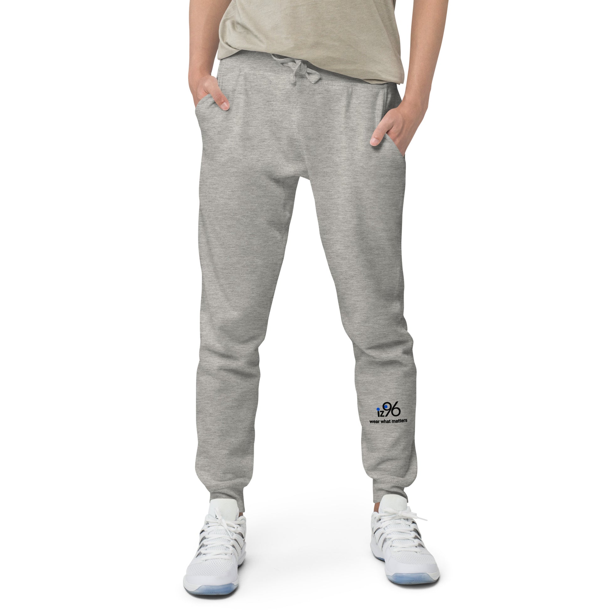 Person wearing gray sweatpants with a logo on a white background