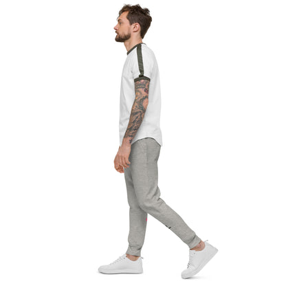 Man wearing a white shirt, gray pants, and white sneakers on a white background