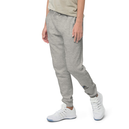Person wearing gray sweatpants with a brand logo on a white background