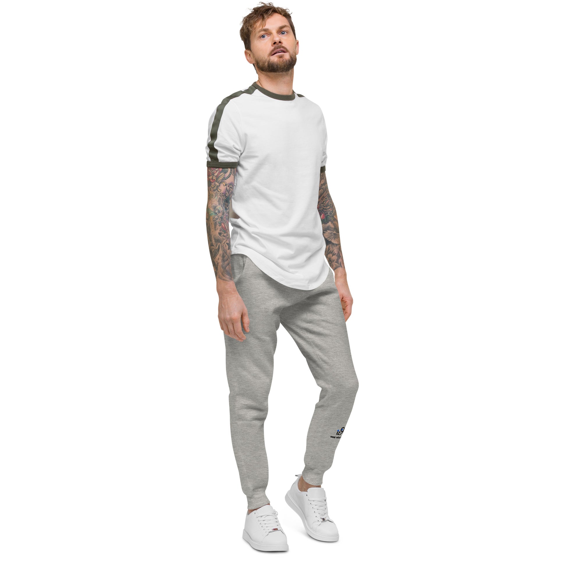 Man wearing a white t-shirt and gray jogger pants on a white background