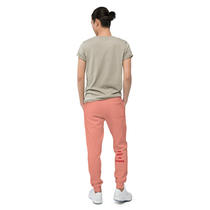 Person wearing a beige t-shirt and rose pants on a white background
