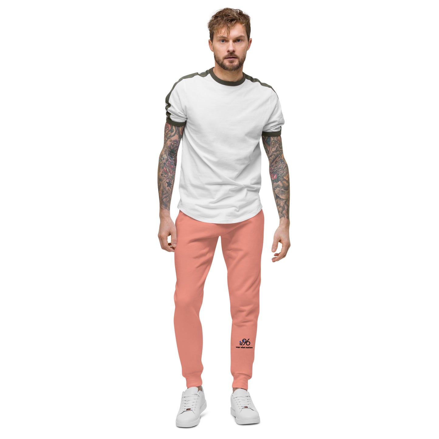 Man wearing a white t-shirt and rose pink pants on a white background