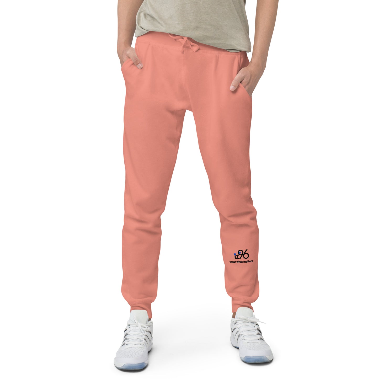 Person wearing rose pink sweatpants with a logo on a white background