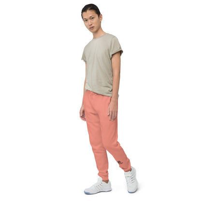 Person wearing a beige t-shirt and rose pink pants on a white background