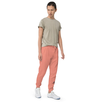 Person wearing a beige t-shirt and rose pink pants on a white background