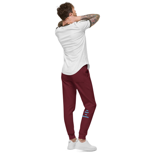 Man wearing a white t-shirt and maroon pants with text on a white background