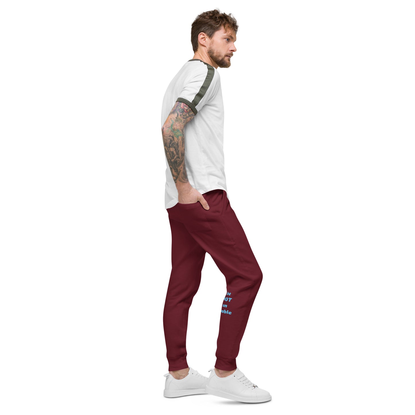 Man wearing a white shirt and maroon pants on a white background
