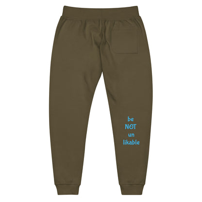Brown sweatpants with blue text 'be NOT un likable' on a white background
