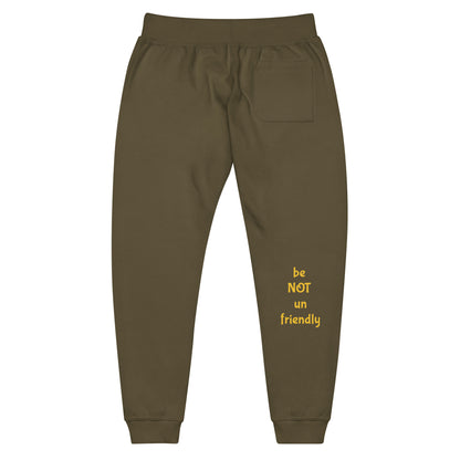 military green sweatpants with yellow text 'be NOT un friendly' on a white background