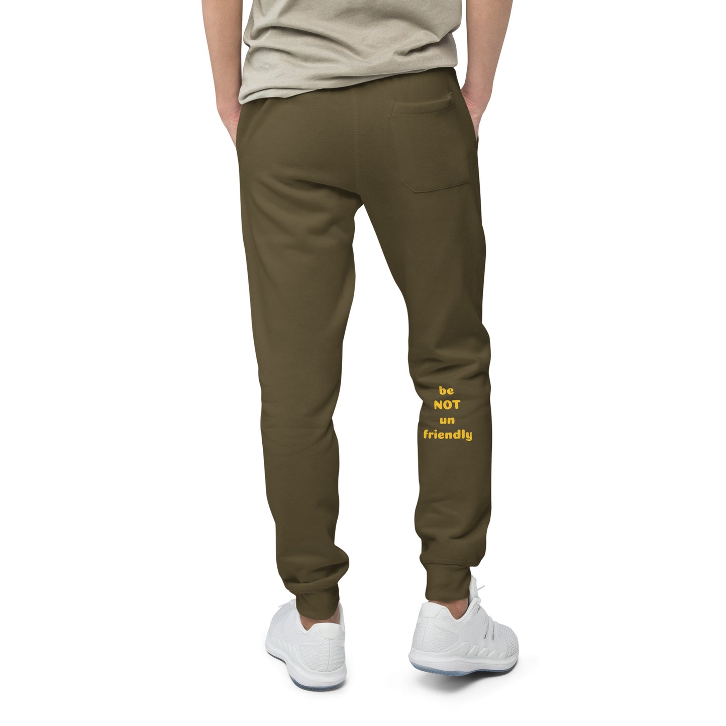 Person wearing military green pants with text and white sneakers on a white background