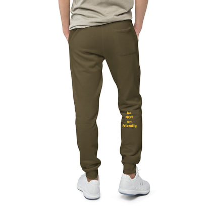 Person wearing military green pants with text and white sneakers on a white background