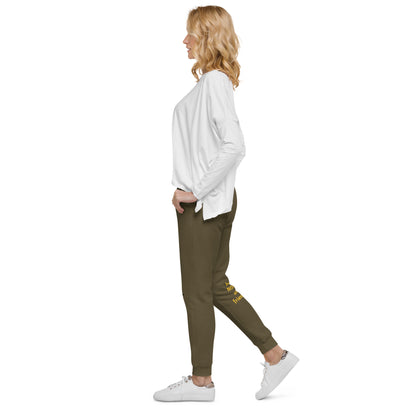 Woman wearing a white shirt and green jogger pants on a white background