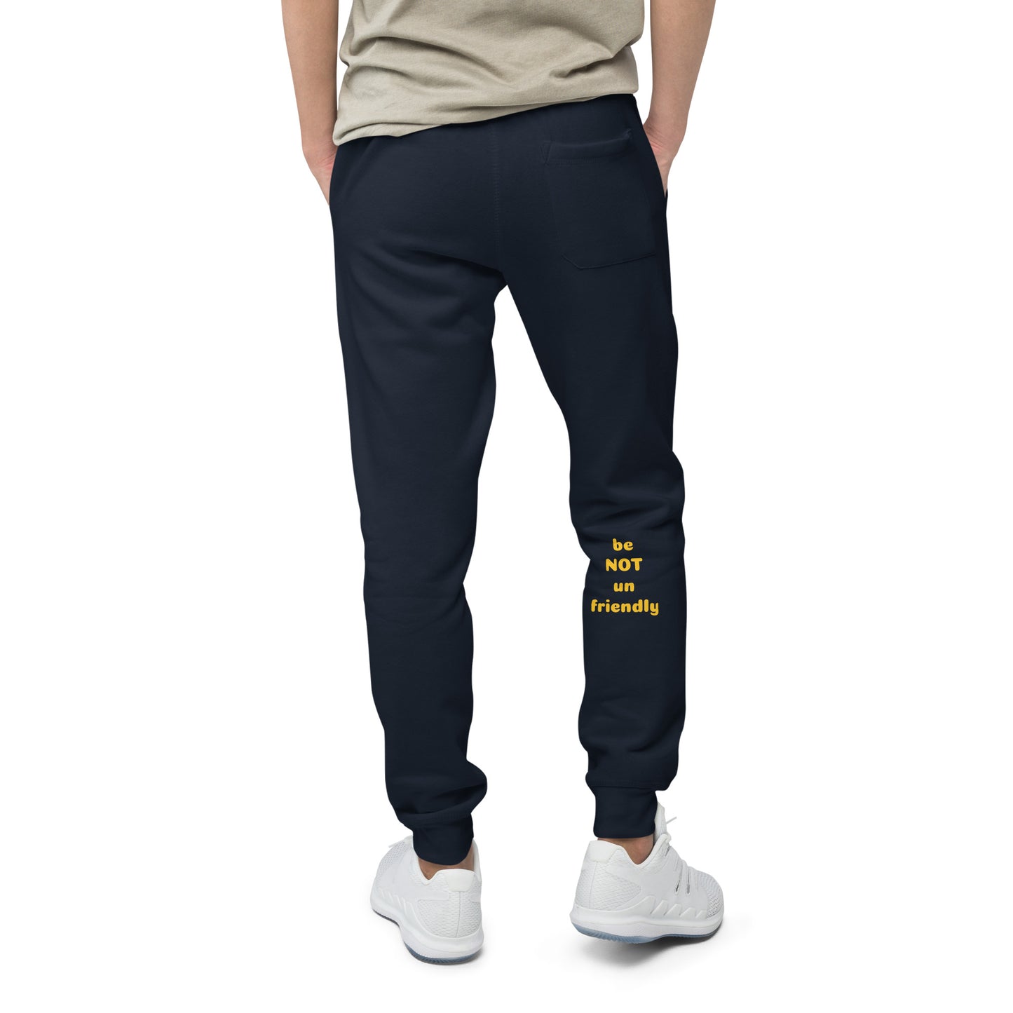 Person wearing navy jogger pants with yellow text on a white background