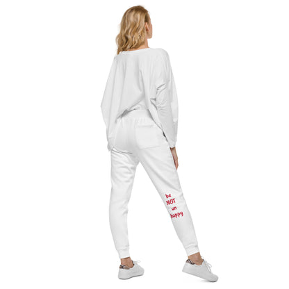 Woman wearing a white tracksuit with text on the pants against a white background