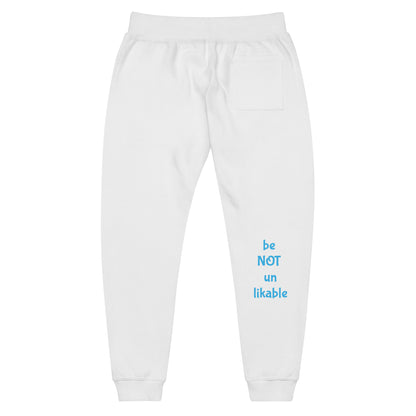 White sweatpants with blue text 'be NOT unlikable' on a white background