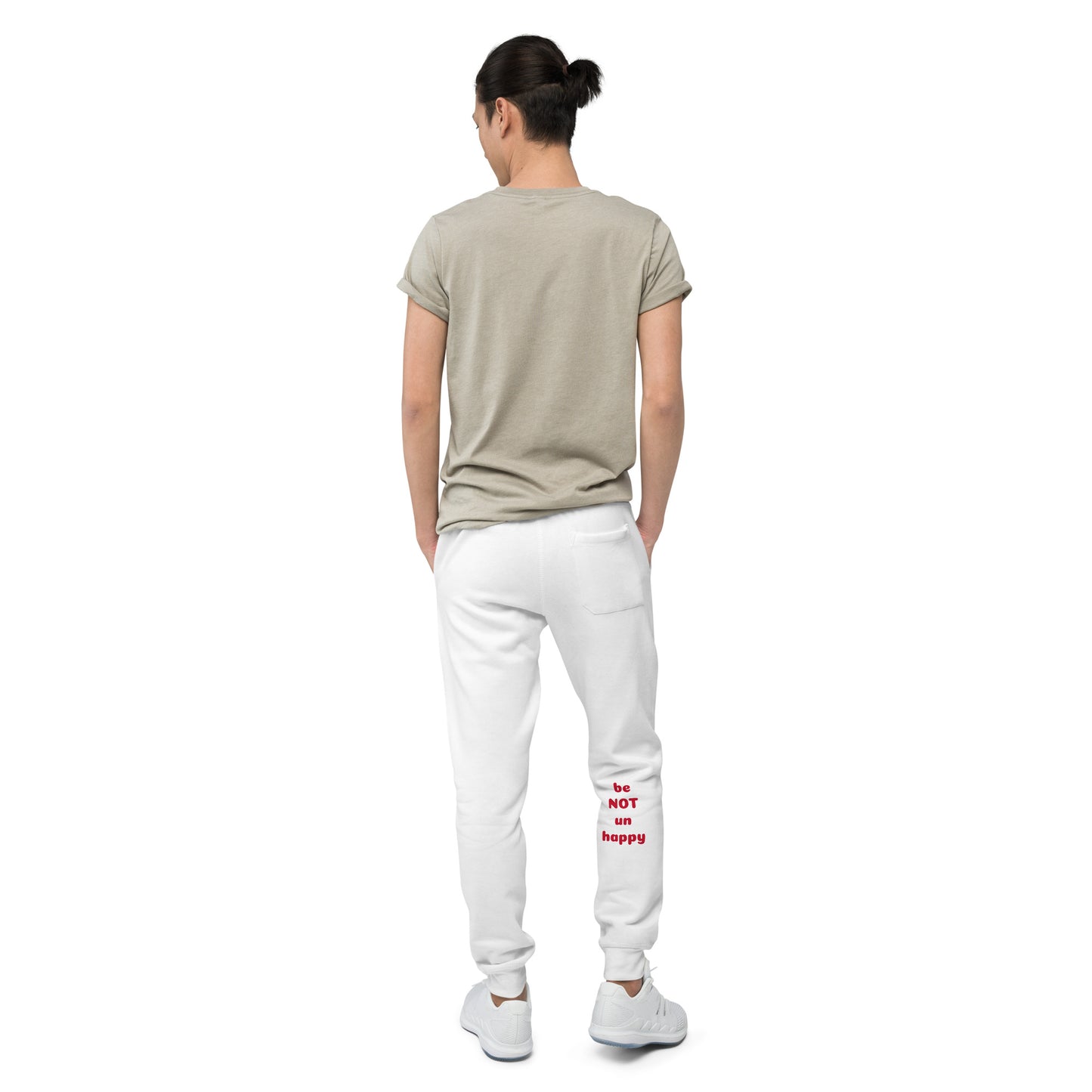 Person wearing a beige t-shirt and white pants with text on a white background