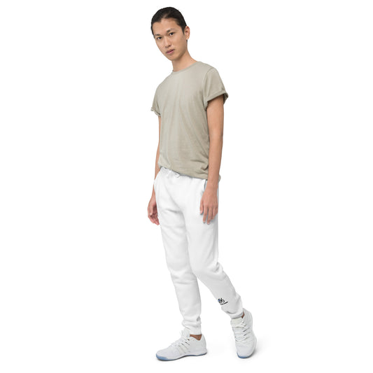Person wearing a beige t-shirt and white pants on a white background