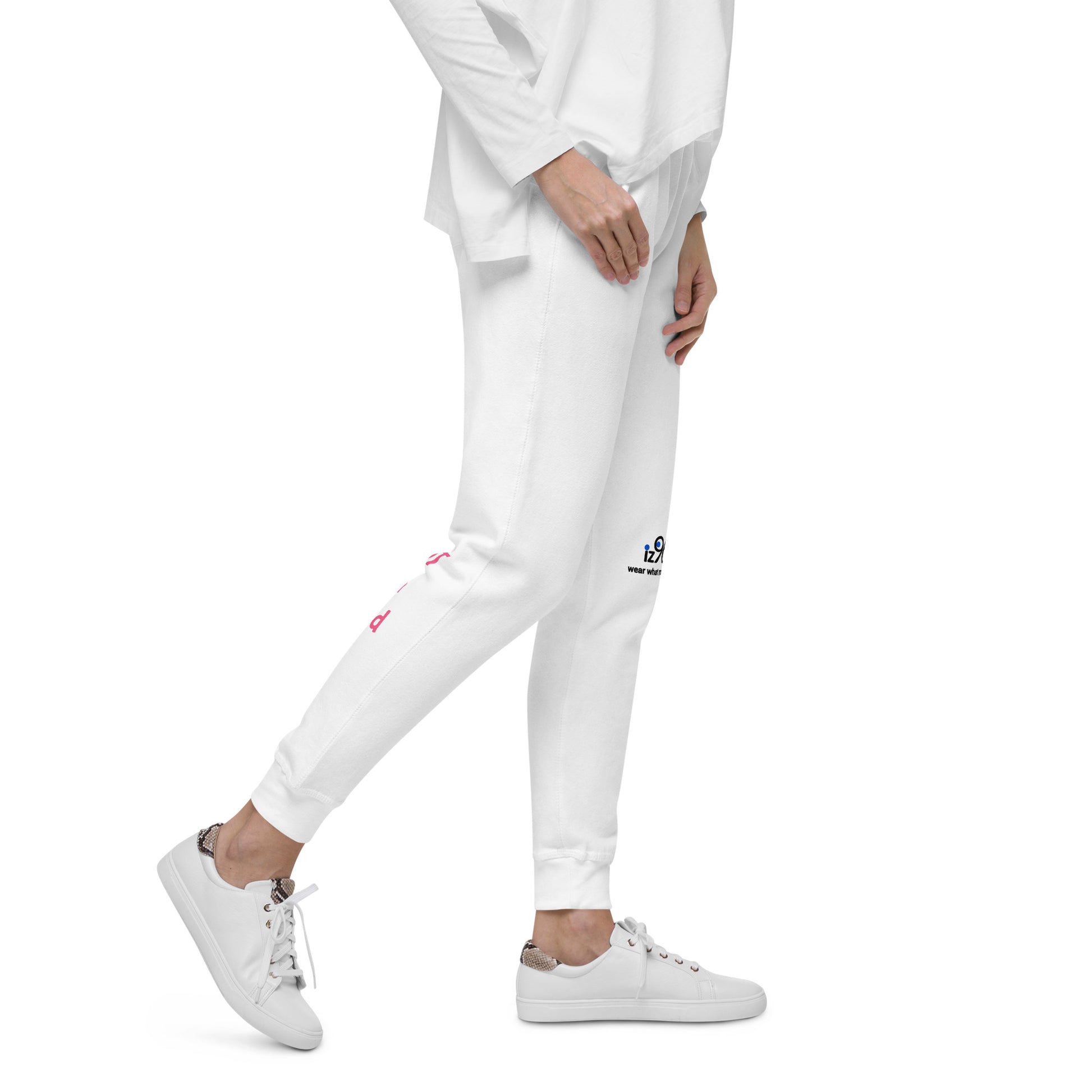 Person wearing white jogger pants with brand logo on a white background