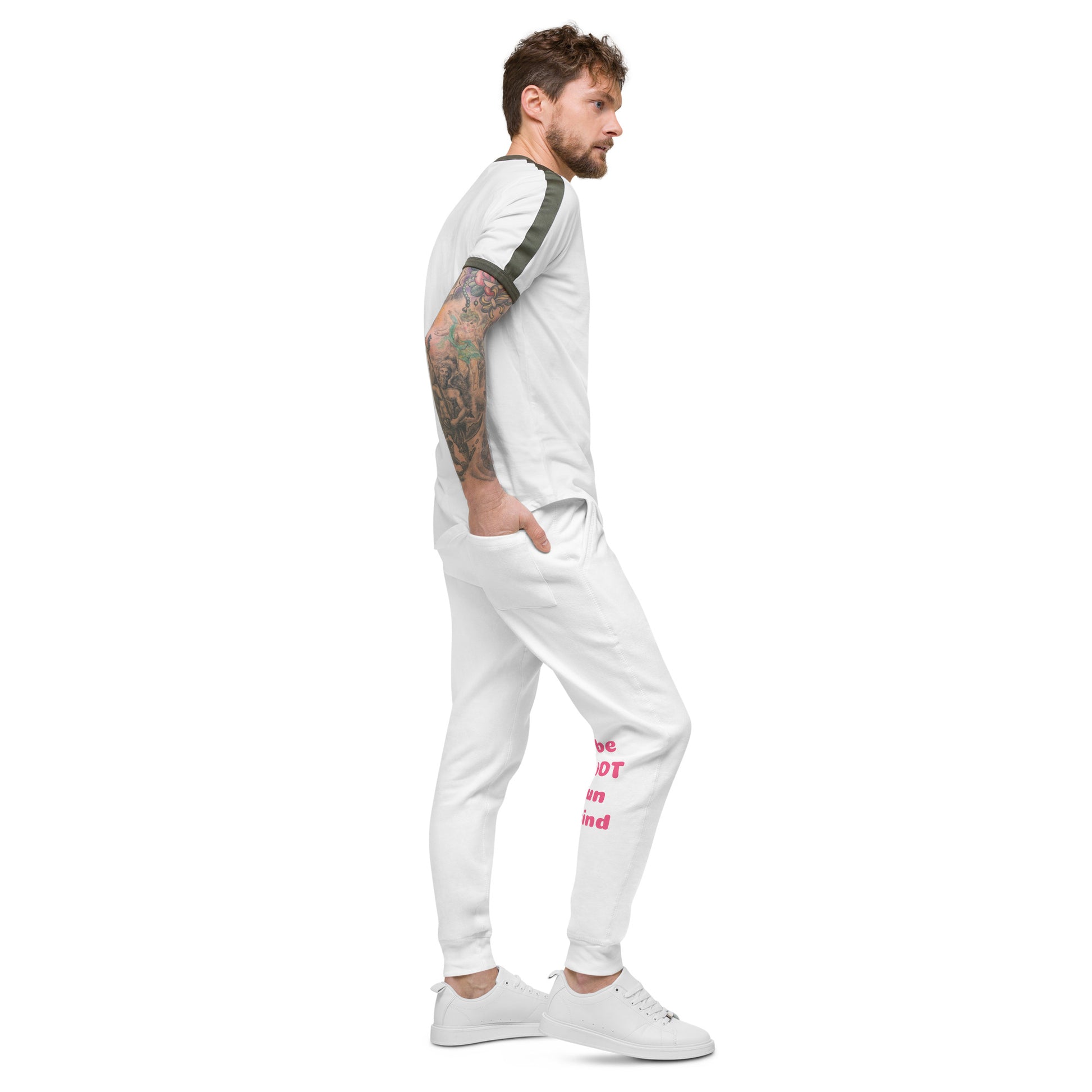 Man wearing a white outfit with text on pants against a white background