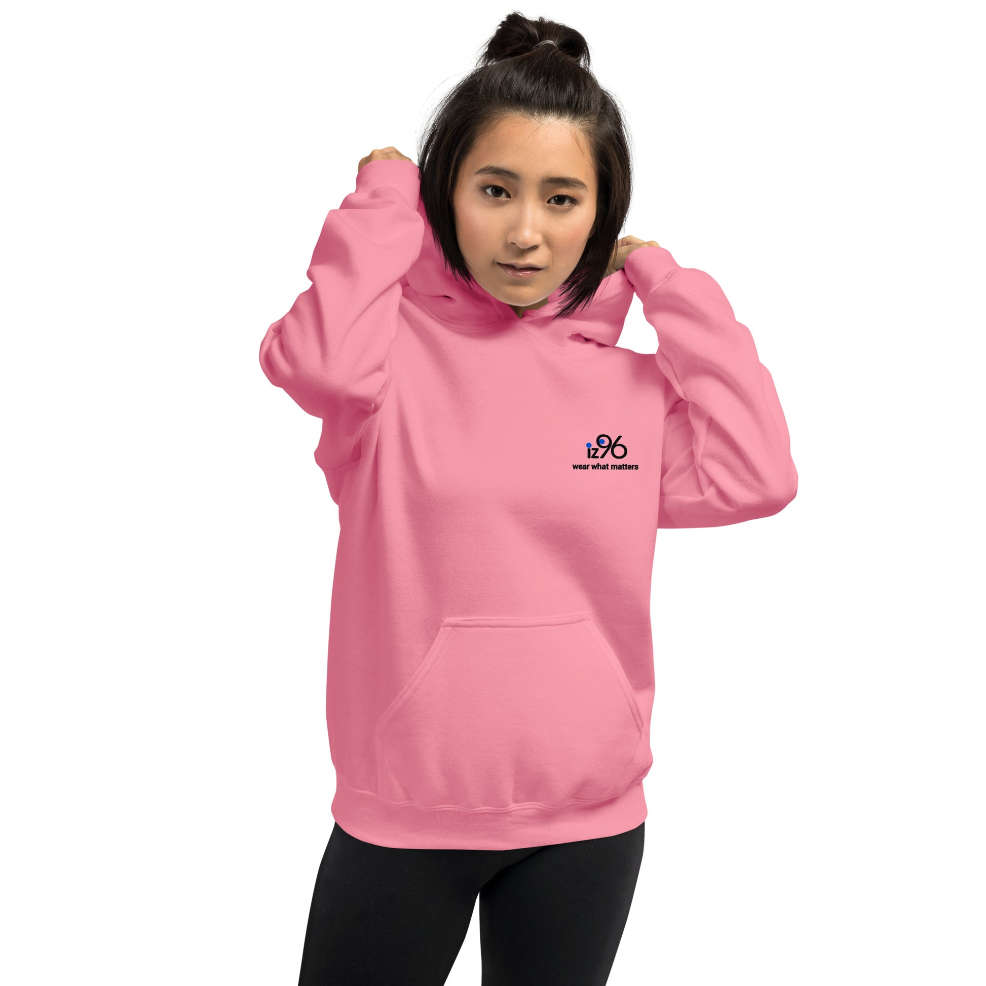 Person wearing a pink hoodie with a logo design on a white background
