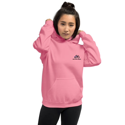 Person wearing a pink hoodie with a logo design on a white background