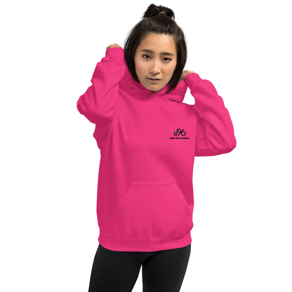 Person wearing a bright pink hoodie with a logo on the chest against a white background