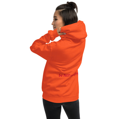 Person wearing an orange hoodie with text on a white background
