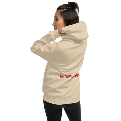 Woman wearing a beige hoodie with a graphic design on a white background