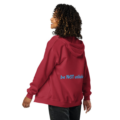 Person wearing a red hoodie with a text on the back, standing against a white background