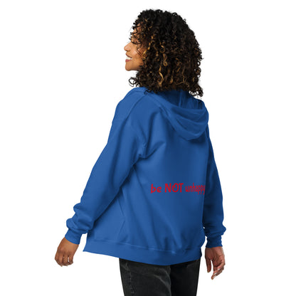 Person wearing a blue hoodie with text on the back, standing against a white background