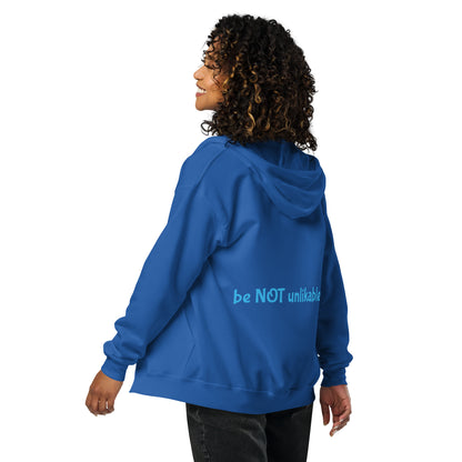 Person wearing a blue hoodie with 'be NOT unlikable' text on the back, on a white background