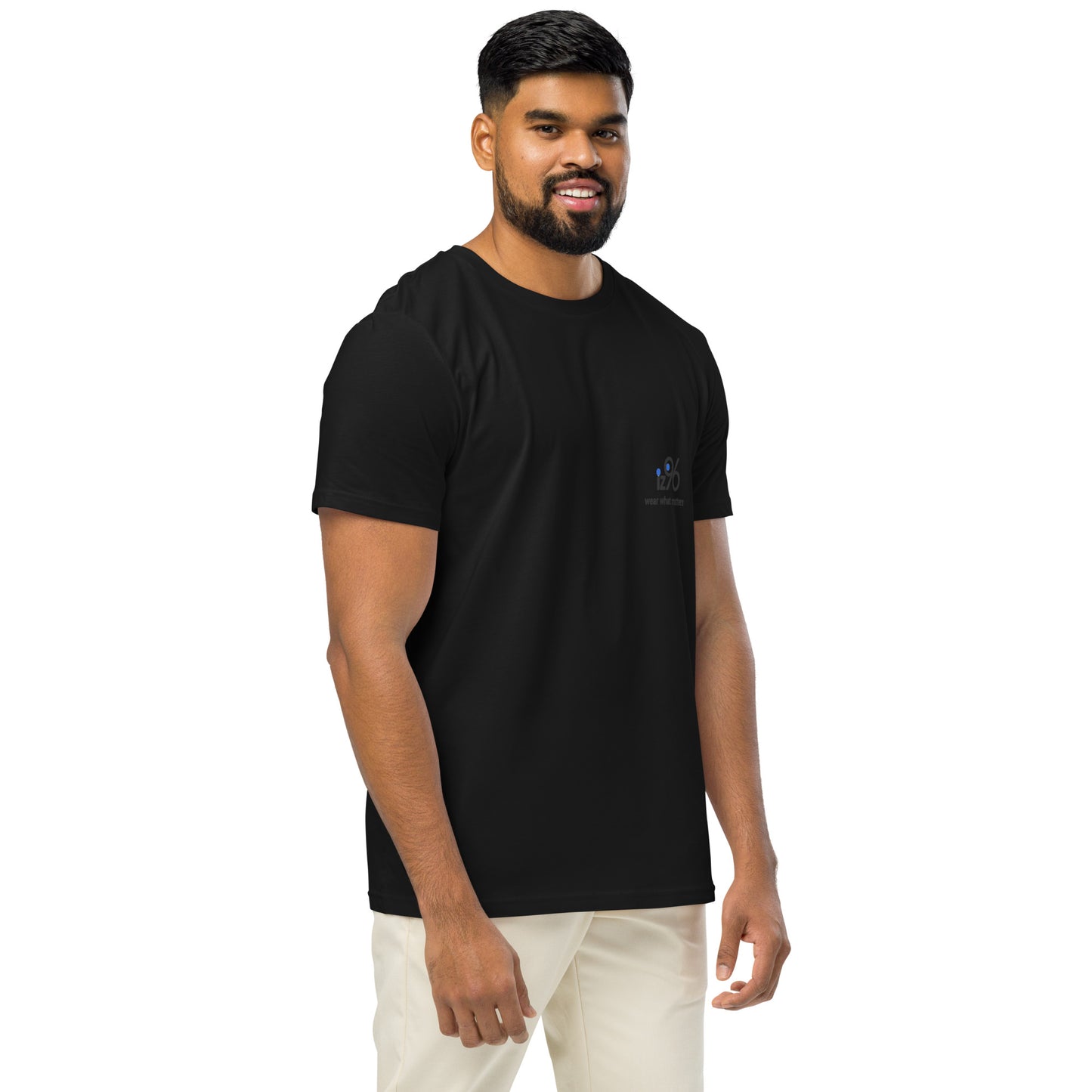 Man wearing a black t-shirt and light-colored pants on a white background