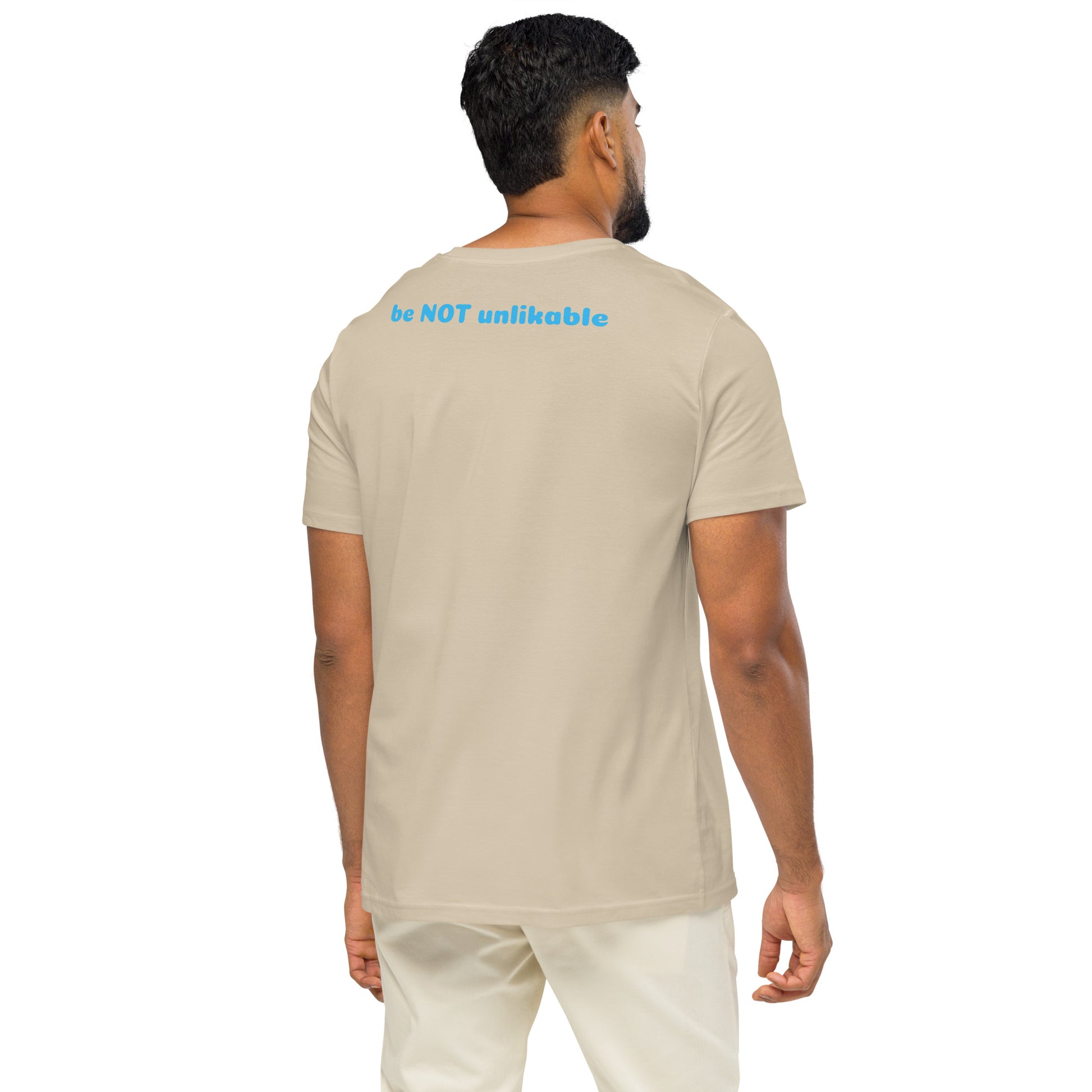 Man wearing a dust t-shirt with 'be NOT unlikeable' text on the back, standing against a white background.