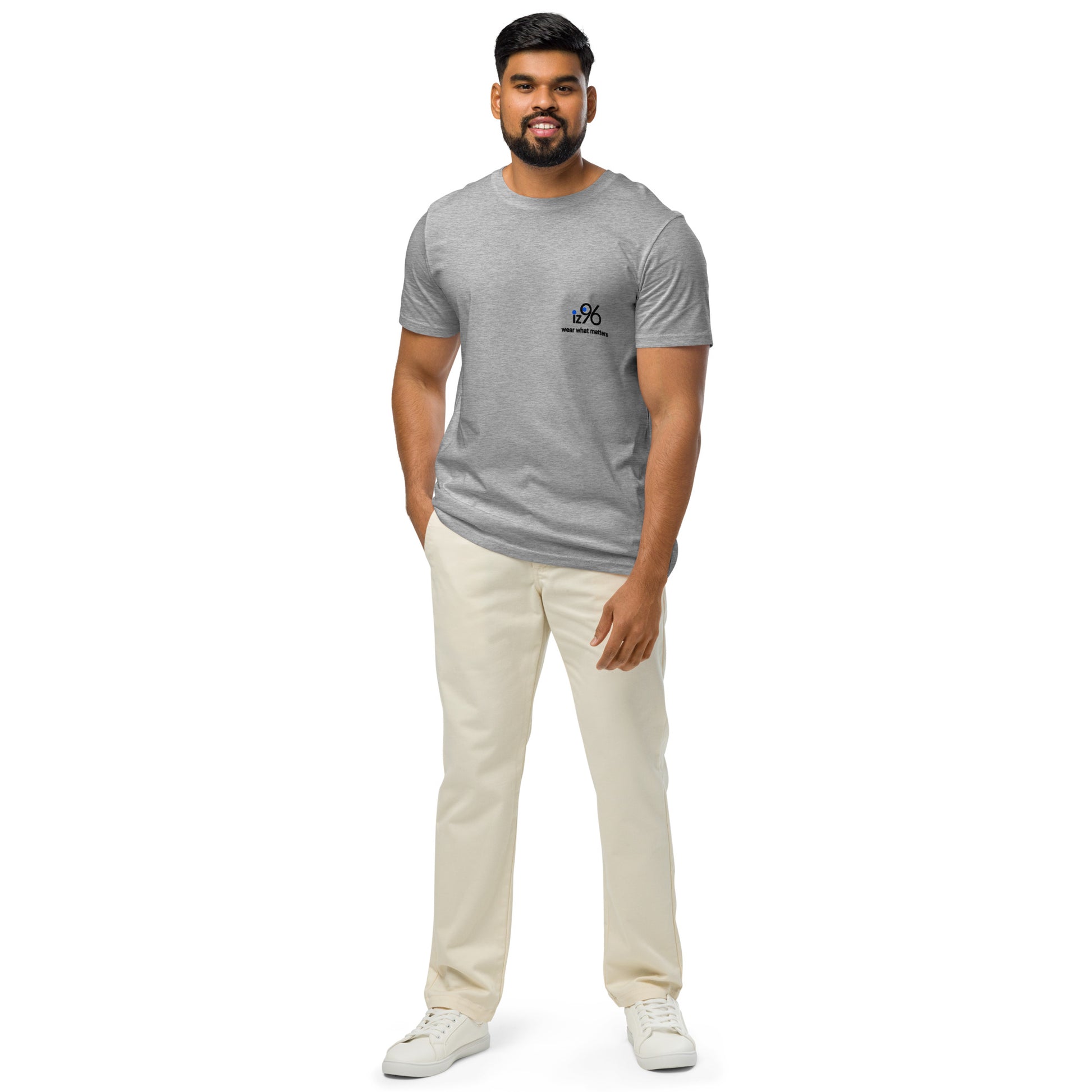 Man wearing a gray t-shirt with logo and beige pants on a white background