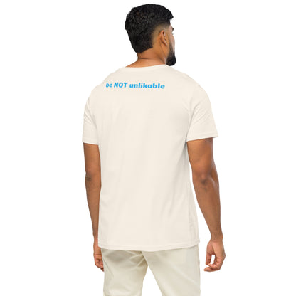 Man wearing a white t-shirt with 'be NOT unlikeable' text on the back, standing against a white background.