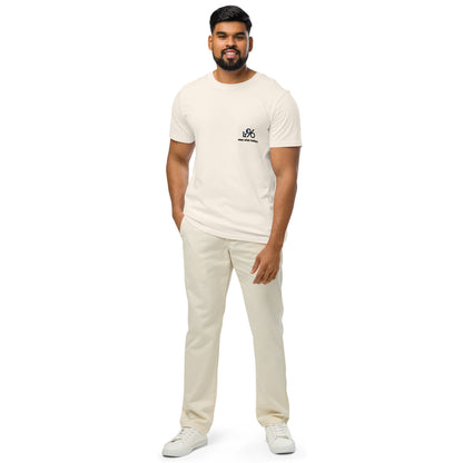 Man wearing a vintage white t-shirt and pants with a logo on a white background