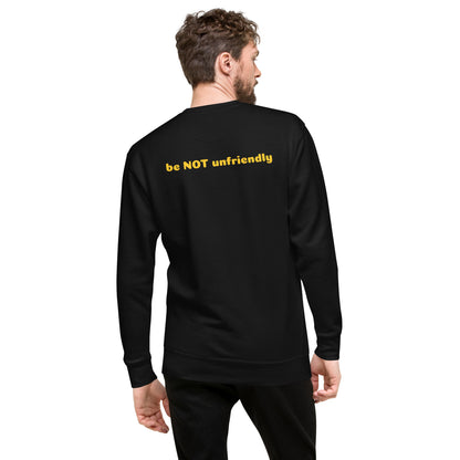 Man wearing a black sweatshirt with yellow text on the back, standing against a white background