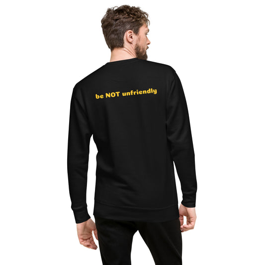 Man wearing a black sweatshirt with yellow text on the back, standing against a white background