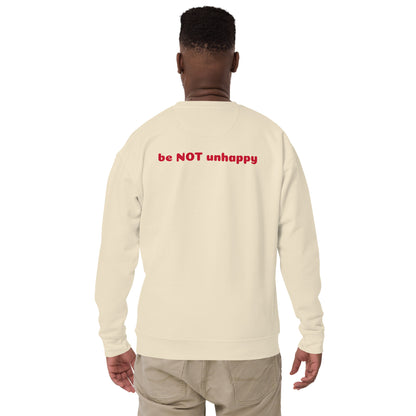 Person wearing a cream long-sleeve shirt with 'be NOT unhappy' text on the back, standing against a white background.
