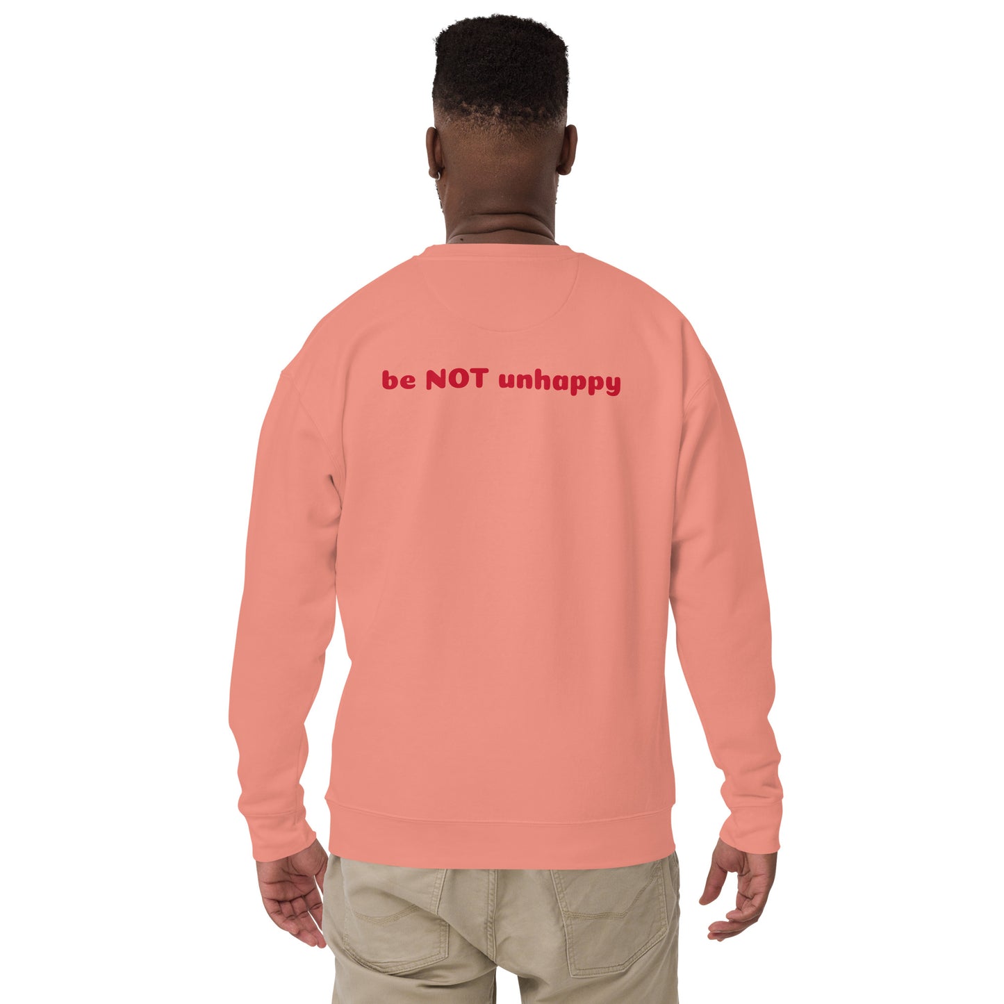 Person wearing a rose pink sweatshirt with red text on the back against a white background